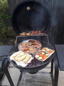 a grill with several different types of food on it at Całoroczny Apartament u Grzegorza in Lidzbark