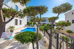 an apartment with a swimming pool and trees at Luxury apartment Hyperion with private pool and garden in Murter