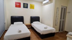 Postel nebo postele na pokoji v ubytování Jade Guesthouse Jonker Melaka