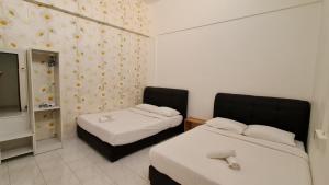 Postel nebo postele na pokoji v ubytování Jade Guesthouse Jonker Melaka