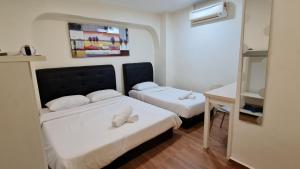 Postel nebo postele na pokoji v ubytování Jade Guesthouse Jonker Melaka