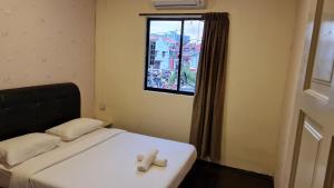 Postel nebo postele na pokoji v ubytování Jade Guesthouse Jonker Melaka