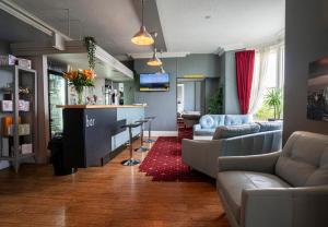 a living room with a couch and a bar in it at The Central Hotel in Llandudno