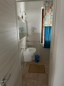 a small bathroom with a sink and a toilet at A Due Passi dal Centro in Favignana