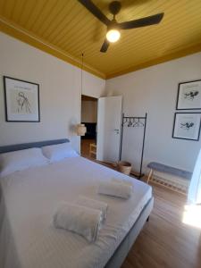 a bedroom with a large white bed with two pillows at Terra del Nonno in Drymon