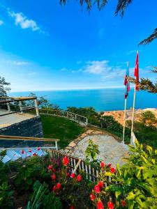 a view of the ocean from a hill with flags at Trabzon Silent Hill Bungalow in Trabzon