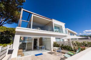 a house with large glass windows and a patio at Aquamaris Design Suite & Spa in Paestum
