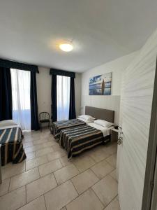 Posteľ alebo postele v izbe v ubytovaní Hotel Alessander