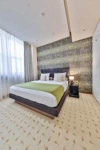 a bedroom with a large bed in a room at Atera Business Suites in Belgrade