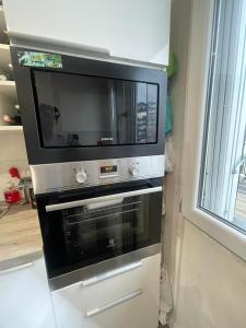 a microwave oven sitting on top of a stove at appartement 65m in Châtillon