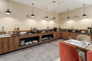 a restaurant with a buffet with a table and chairs at Starlit Suites Newtown Kolkata in kolkata