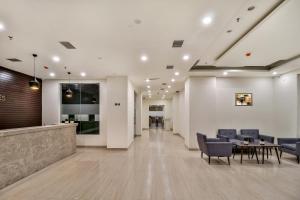 an office lobby with chairs and a table at Starlit Suites Newtown Kolkata in kolkata +37 photos