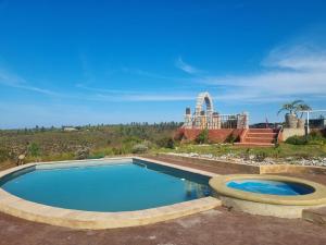 a swimming pool in the middle of a yard at Rainforest Ridge Eco Resort in The Crags
