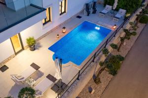 an overhead view of a swimming pool in a house at Luxury apartment Hyperion with private pool and garden in Murter +107 photos