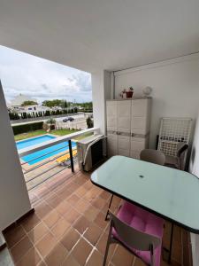 a kitchen with a table and chairs and a pool at Portobello Verena in Port de Pollensa