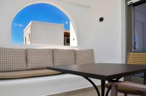 a dining room with a couch and a table at Lilian Studios in Koufonisia