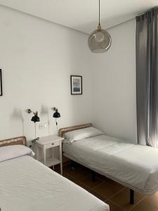 En eller flere senge i et værelse på Casa Palacio de los Leones