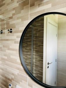 a round mirror on a wall with a door at Cozy studio Bečići in Becici +14 photos