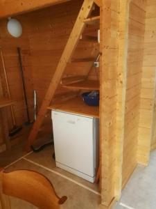 a room with a staircase in a tiny house at Chalet Blockhaus auf Camping - b48513 in Oberwil