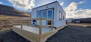a tiny house sitting on top of a field at Hagi 2 Road 62 in Patreksfjörður