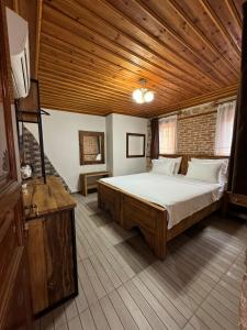 a bedroom with a large bed with a wooden ceiling at Casa Franco Old Town in Antalya