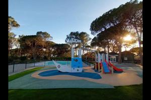 a playground with a slide in a park at Le Papillon Maitiss in Saint-Raphaël
