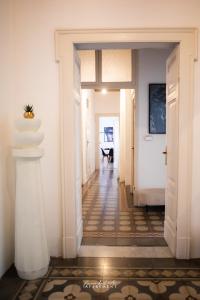 a hallway with white walls and a hallway with a table at La via dell'arte Apartment in Pescara