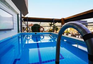 a swimming pool with a water slide in a building at ERGÜN OTEL in Alanya