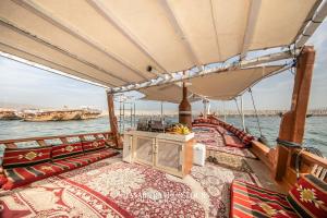 a boat on the water with lots at Overnight Dhow - 1 Night 2 Days in Khasab