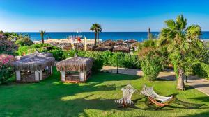an aerial view of a resort with chairs and the beach at Port Nature Luxury Resort in Belek