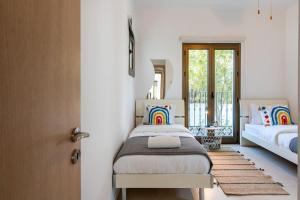 a bedroom with a bed and a door with a window at Lumina 2-Bedroom Villa and Pool in Ayia Napa in Ayia Napa +23 photos