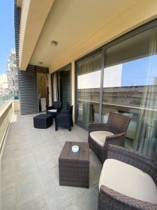 a balcony with chairs and tables on a building at Spinola Residence St Julians in St Julian's