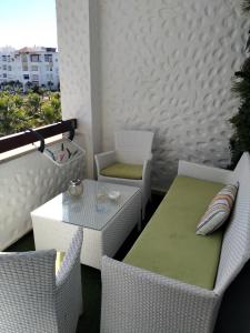 a balcony with a table and chairs on a balcony at assilah marina golf assilah in Asilah