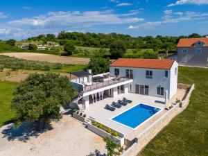 an aerial view of a house with a swimming pool at Villa Sunset Grusi ZadarVillas in Briševo