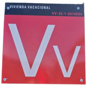 una señal roja con la letra V en ella en Finca Ancestros en Tejeda