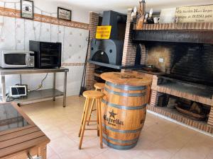 a room with a fireplace and a barrel and a table at Casa de Gaia in Alicante