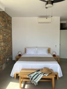 a bedroom with a large bed and a wooden table at The Mavrolitharo Residence in Akti Salonikiou