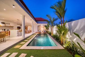 an indoor swimming pool in the backyard of a house at *NEW* Modern 3BD Villa in quiet Perenenan! in Canggu