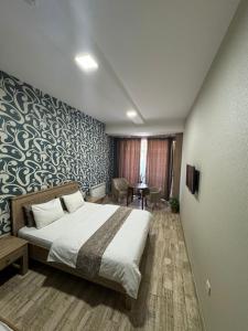 a hotel room with a bed and a desk at Гостиница Низами Стрит in Baku