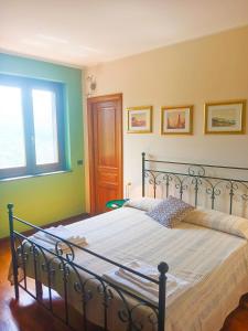 a bedroom with a bed with a metal frame at La quercia di Massena in Lauria Inferiore