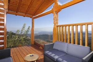 a screened in porch with a couch and a table at Ohn-Bar Guesthouse in Amirim