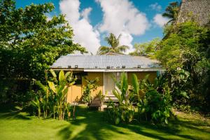 a house in the middle of a yard at Coconut Suite in General Luna