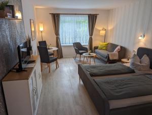 a living room with a couch and a tv at Haus Schmidt in Alt Bukow
