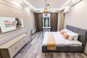 a bedroom with a bed and a desk in it at Apartment KeyGo #0010 next to St Sarkis Church in Yerevan