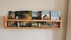 a book shelf filled with books on a wall at De Sleeuwijkerwaard in Sleeuwijk