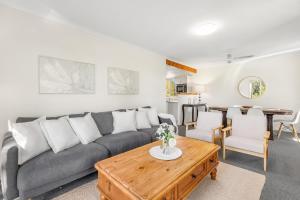 a living room with a couch and a table at Madigan Cottages - Settlers Cottage in Lovedale