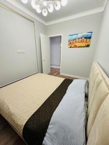 a bedroom with a bed in a room at Апартаменты в ЖК Sezim Qala Senim-3 (5 этаж) in Astana
