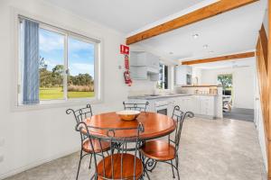 a kitchen and dining room with a table and chairs at Madigan Cottages - Settlers Cottage in Lovedale +17 photos