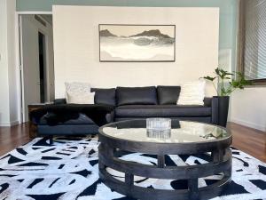 a living room with a couch and a coffee table at #603 Cartwright - The Nighthawk in Cape Town