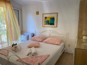 a bedroom with a white bed with towels on it at Villa Terra Nostra Hvar in Hvar